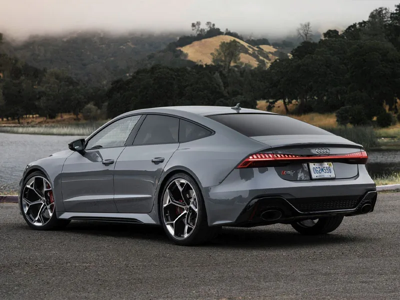 A grey Audi RS 7 Sportback on a hillside road