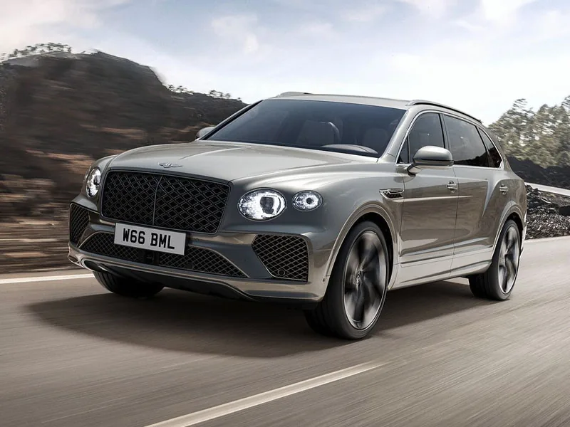 A grey Bentley Bentayga on a mountain road