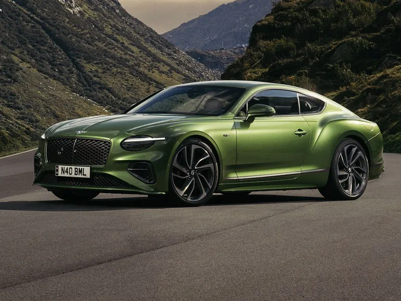 A green Bentley Continental GT on a mountain pass