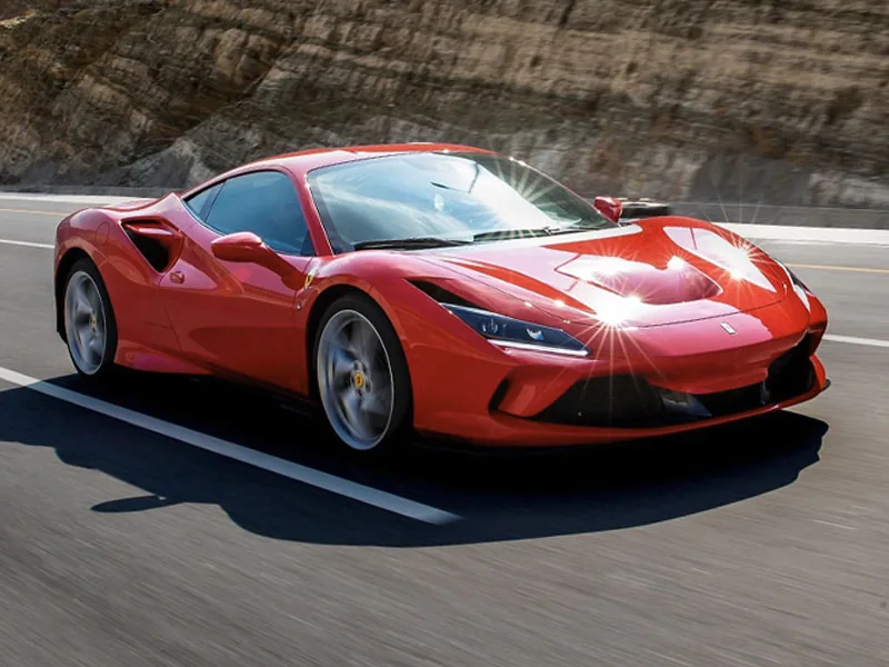 A red Ferrari F8 Tributo cornering on a race circuit