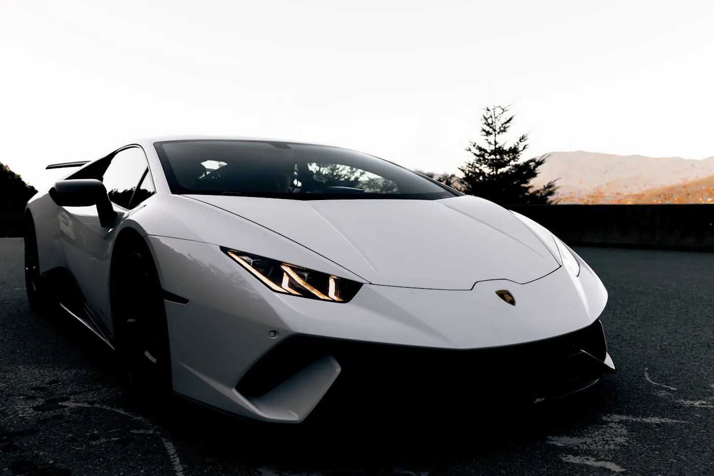 A white Lamborghini Huracán Performante in low light