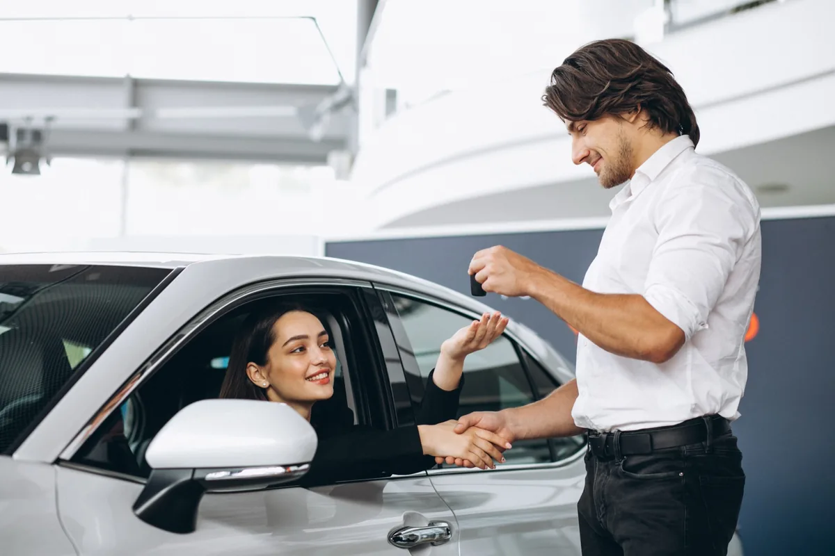 A driver being handed the keys to a replacement car